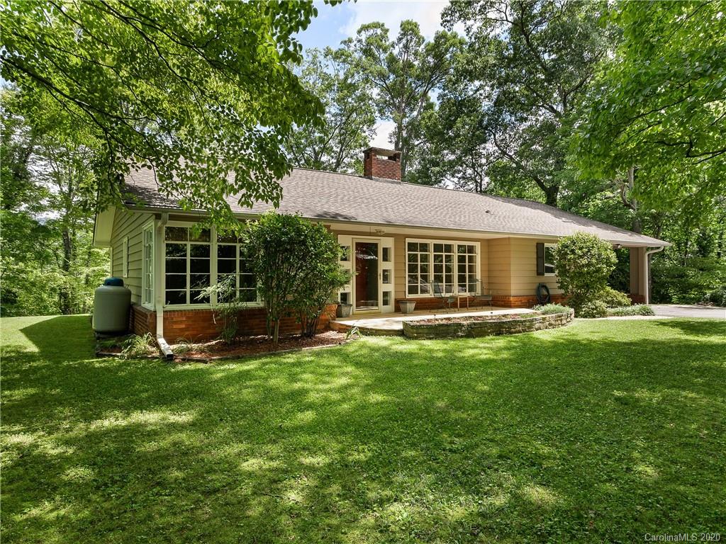 434 Hogback Mountain Road Tryon, NC 28782 - Photo 5 of 37 a view of a house with a backyard and a large tree