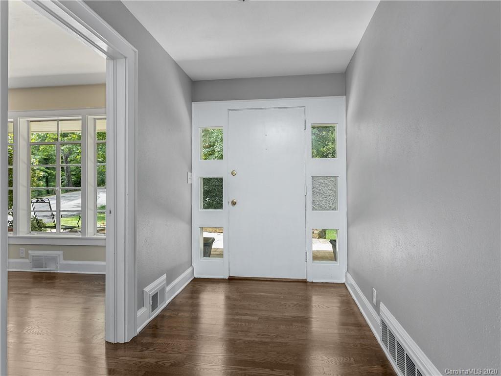 434 Hogback Mountain Road Tryon, NC 28782 - Photo 6 of 37 a view of an empty room with window and wooden floor