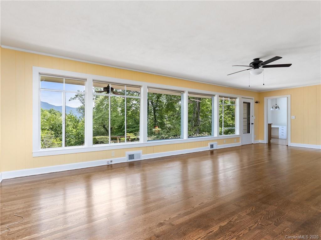 434 Hogback Mountain Road Tryon, NC 28782 - Photo 7 of 37 a view of an empty room with wooden floor and a window
