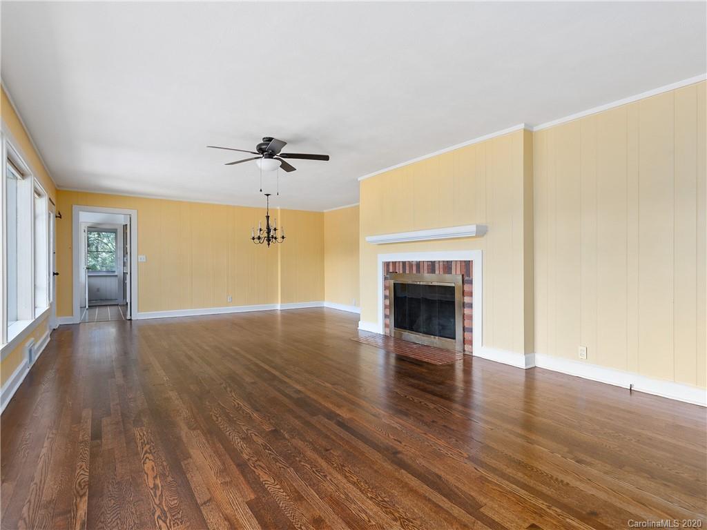434 Hogback Mountain Road Tryon, NC 28782 - Photo 8 of 37 a view of an empty room with a fireplace and wooden floor