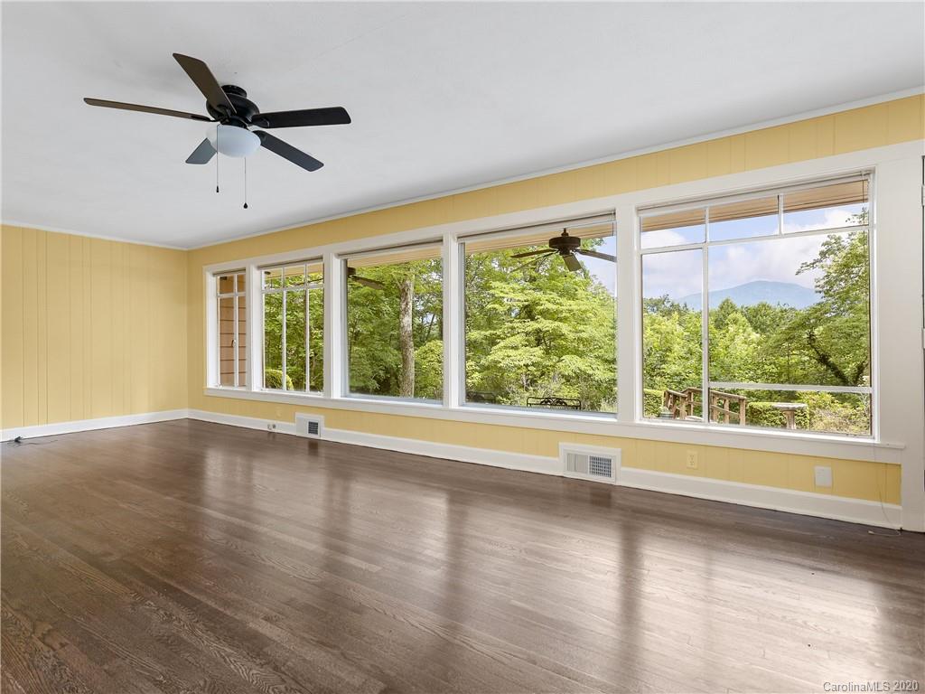 434 Hogback Mountain Road Tryon, NC 28782 - Photo 10 of 37 a view of empty room with wooden floor and fan