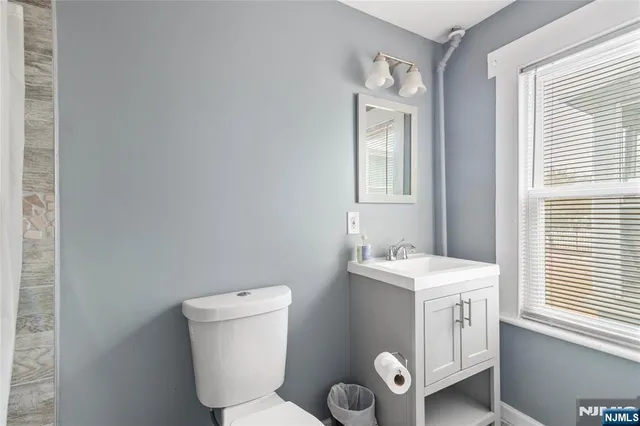 a bathroom with a toilet sink and mirror