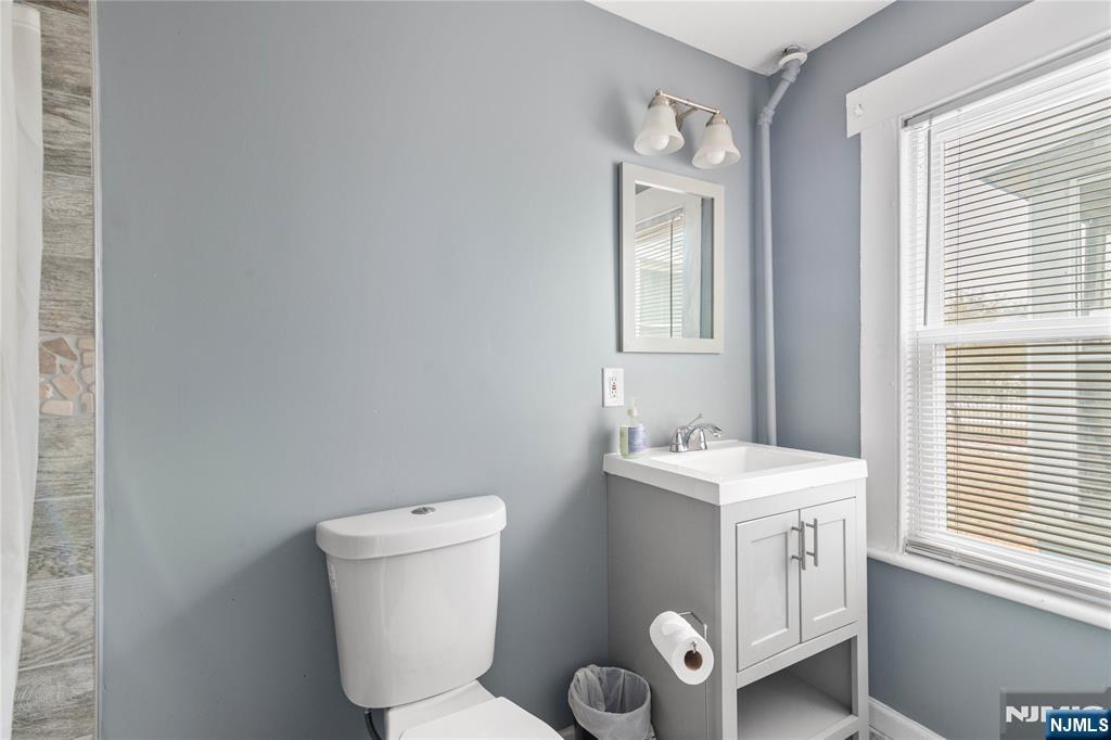 354 Hayward Street Orange, NJ 07050 - Photo 16 of 18 a bathroom with a toilet sink and mirror