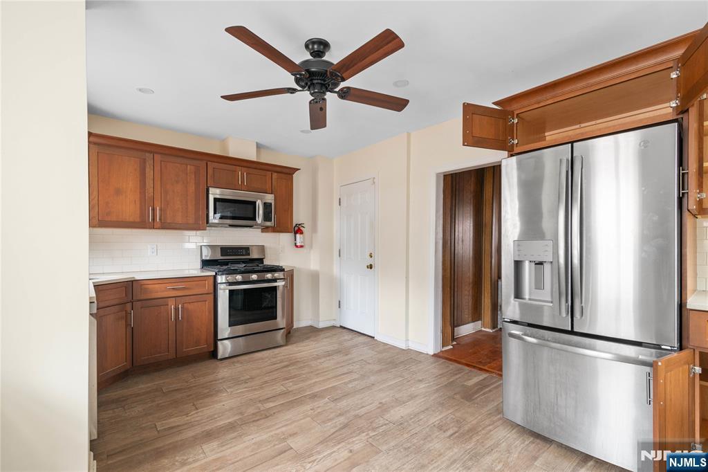 354 Hayward Street Orange, NJ 07050 - Photo 4 of 18 a kitchen with stainless steel appliances granite countertop a refrigerator a stove top oven a sink and dishwasher