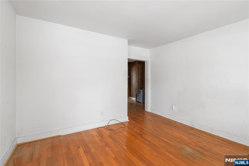 354 Hayward Street Orange, NJ 07050 - Photo 6 of 18 a view of an empty room with wooden floor