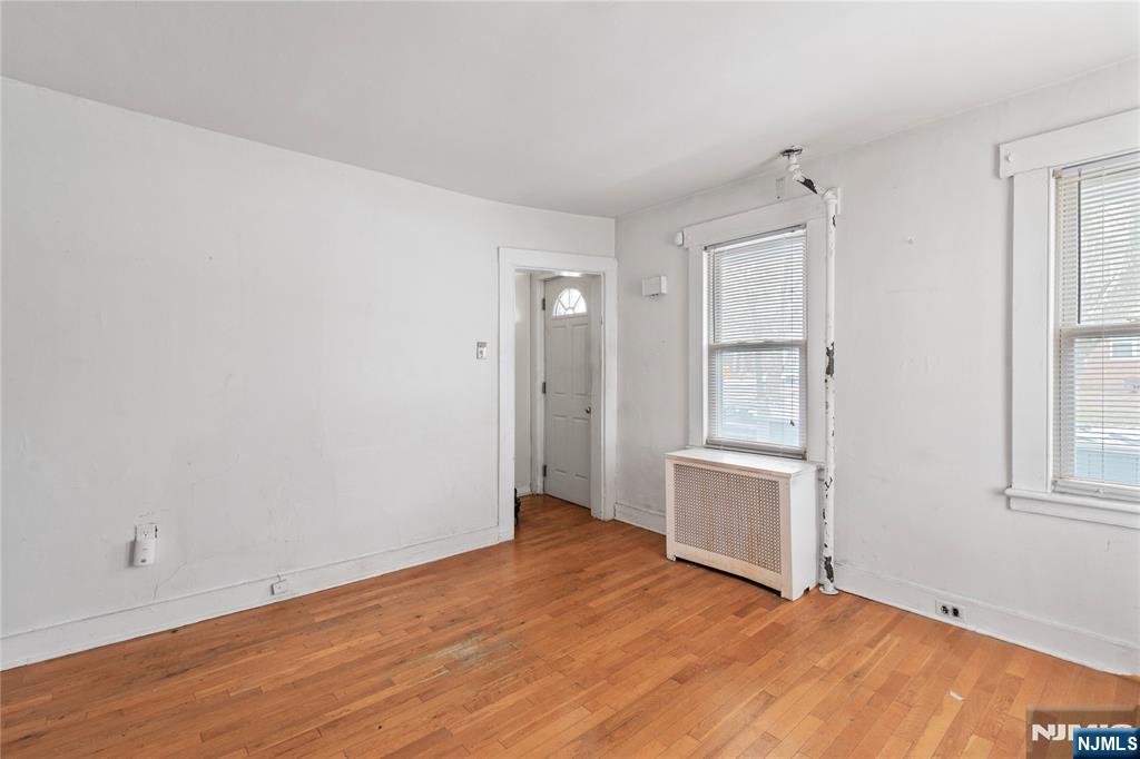 354 Hayward Street Orange, NJ 07050 - Photo 7 of 18 an empty room with cabinet and windows