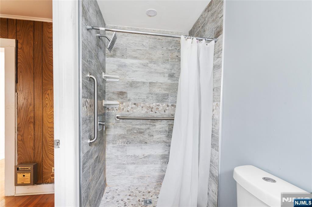 354 Hayward Street Orange, NJ 07050 - Photo 9 of 18 a bathroom with a shower and a toilet