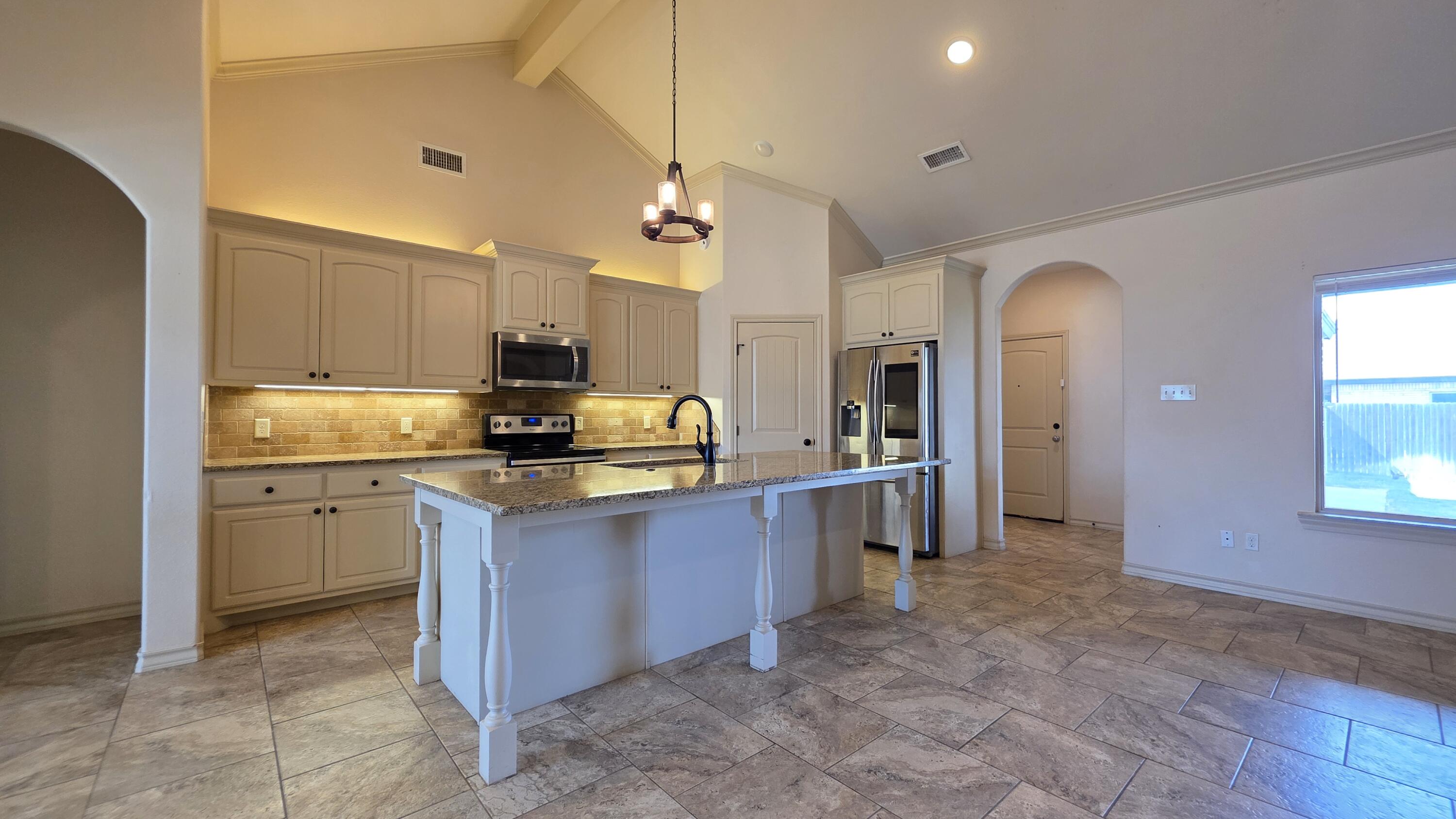 5234 Kemper Street Lubbock, TX 79416 - Photo 6 of 28 a kitchen with stainless steel appliances granite countertop a refrigerator a stove a sink and a oven