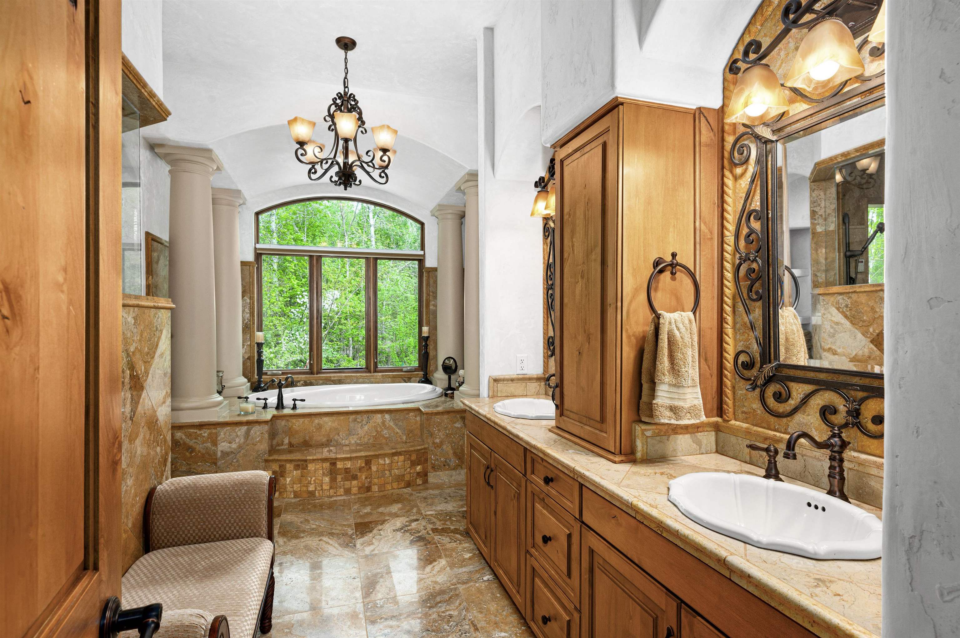 3993 Scenic View Road Moose Lake, MN 55767 - Photo 10 of 48 Primary bathroom with soaking tub, decorative columns, and plenty of natural light.