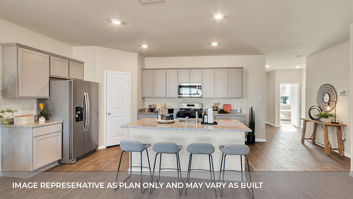 183 Balmorhea Street Kyle, TX 78640 - Photo 14 of 34 a kitchen with stainless steel appliances wooden floors and wooden cabinets