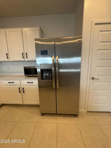 a kitchen with white cabinets and white appliances