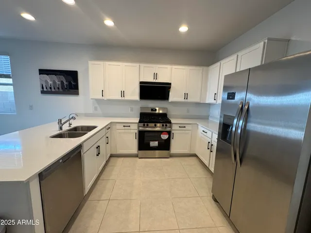 a kitchen with a sink cabinets and stainless steel appliances