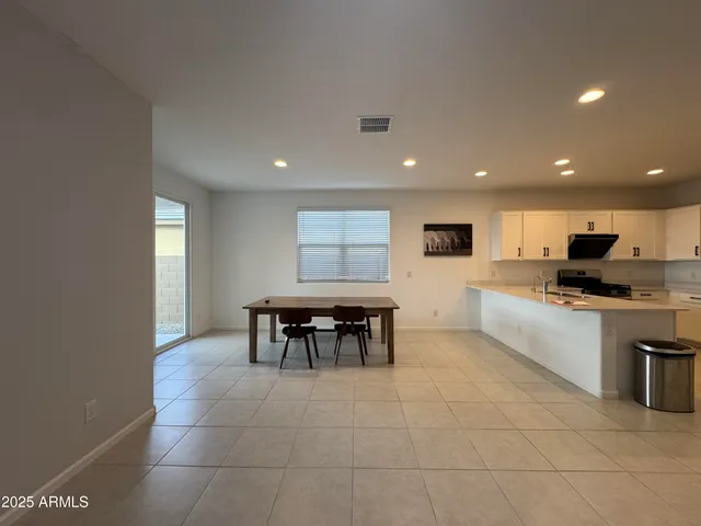 a kitchen with stainless steel appliances dining table and chairs
