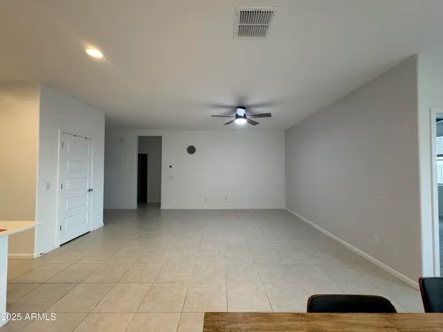 a view of an empty room with a ceiling fan