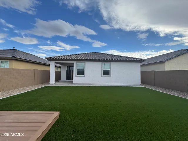 a view of a backyard with plants and a garden