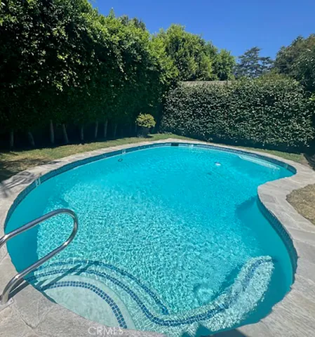 a view of a swimming pool with a yard