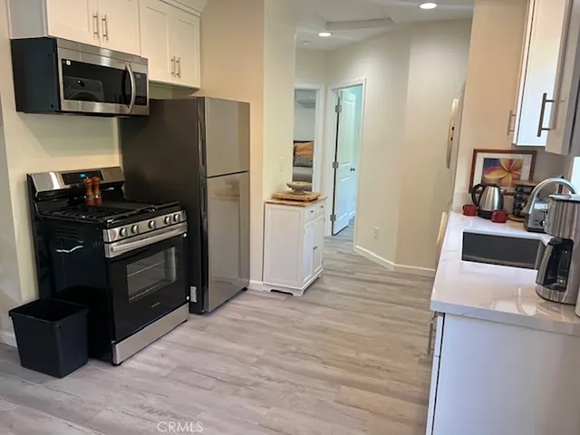a kitchen with a refrigerator stove and microwave