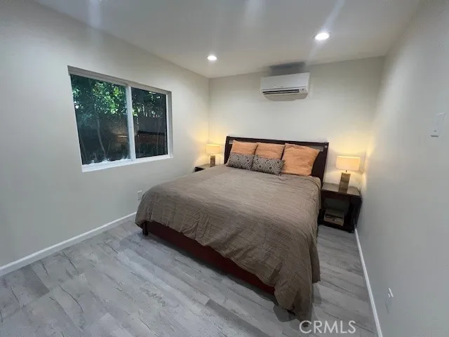 a large bed sitting in a bedroom next to a window