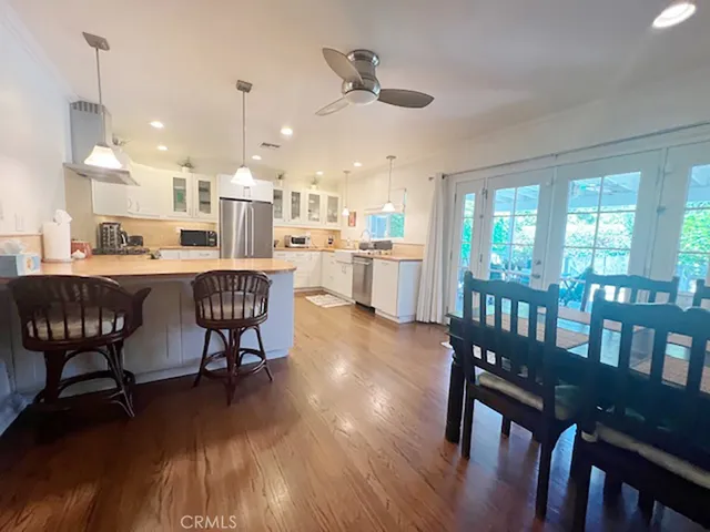 a dining room with furniture a rug and wooden floor