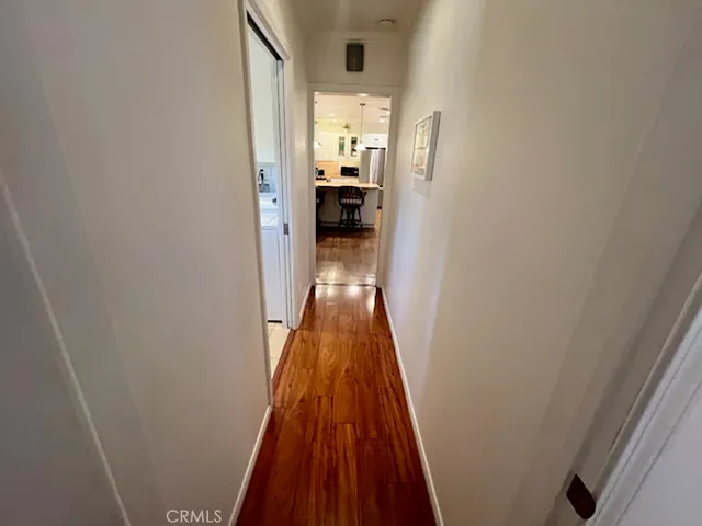 a view of a hallway view with wooden floor and furniture