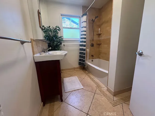 a bathroom with a bathtub and shower