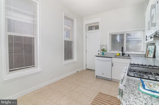a close view of a faucet a sink and a window