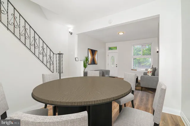 an empty room with wooden floor and stairs