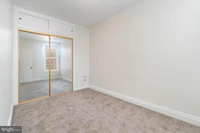 a bedroom with a bed and a potted plant