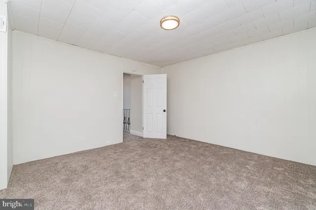 a view of an empty room with a cabinet