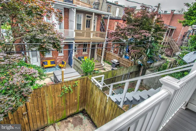 a view of a house with a tree in the background