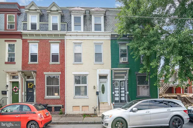 a front view of a building with parking space