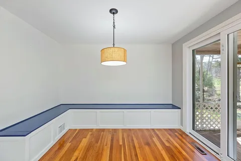 a view of a room with wooden floor and outdoor view