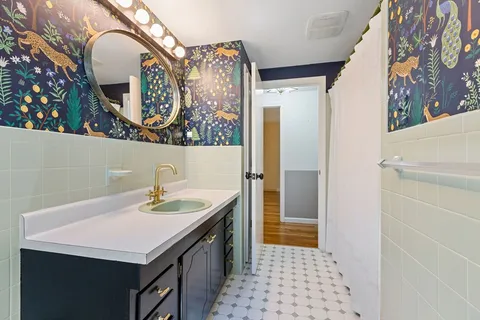 a bathroom with a sink a vanity and a mirror