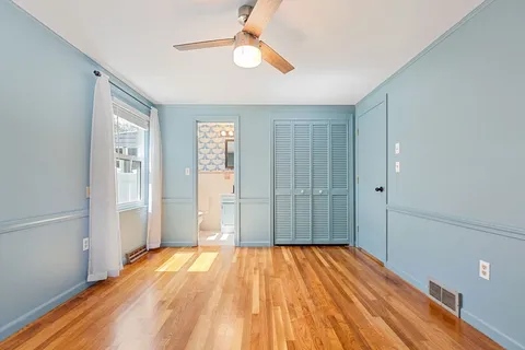 a view of a room with wooden floor and empty room