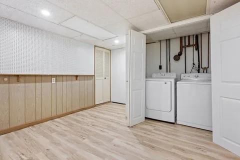 a view of a hallway with entryway wooden cabinet and entryway