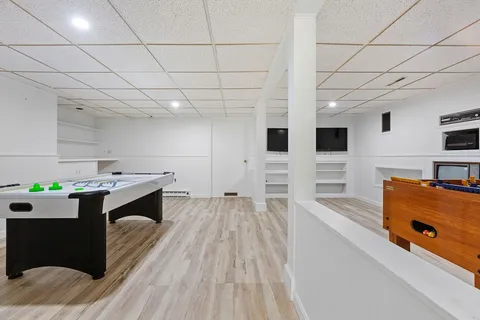 a large white kitchen with a stove a sink dishwasher and wooden cabinets