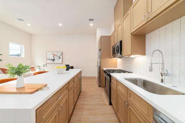 a kitchen with a sink and stove