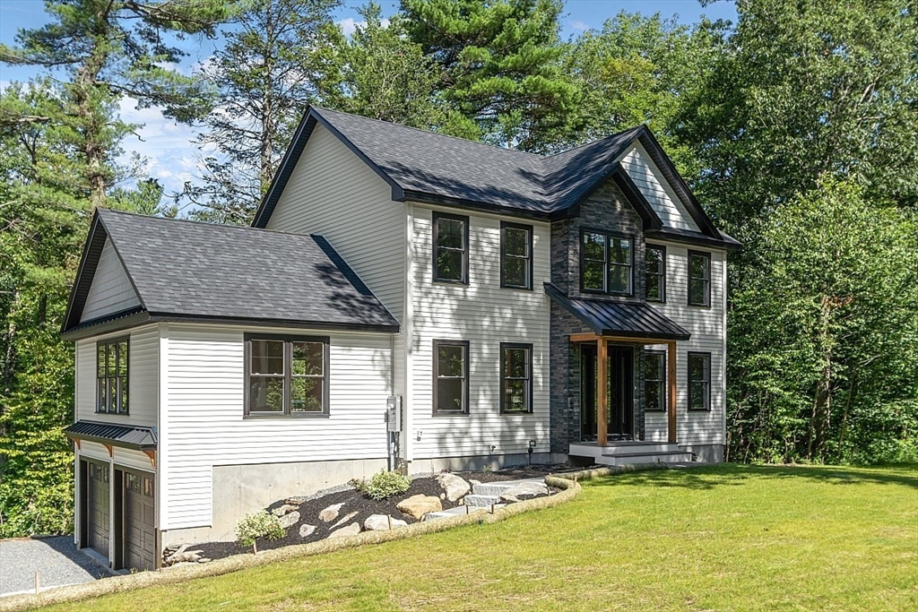 98 Knower Road Westminster, MA 01473 - Photo 1 of 42 a front view of a house with yard chairs and chandelier