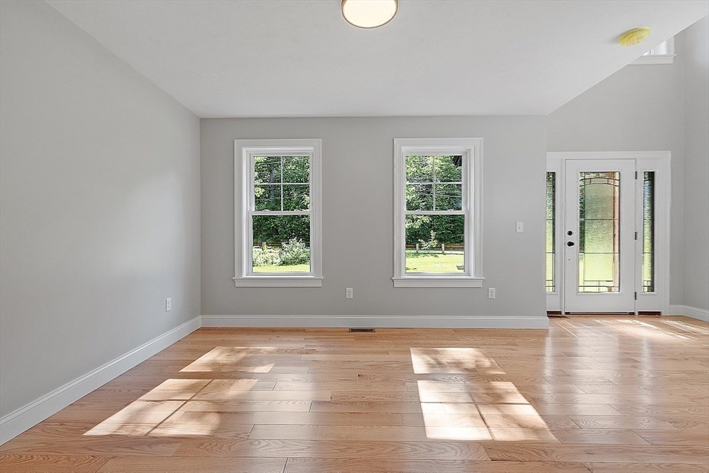 98 Knower Road Westminster, MA 01473 - Photo 14 of 42 a view of an empty room with wooden floor and a window