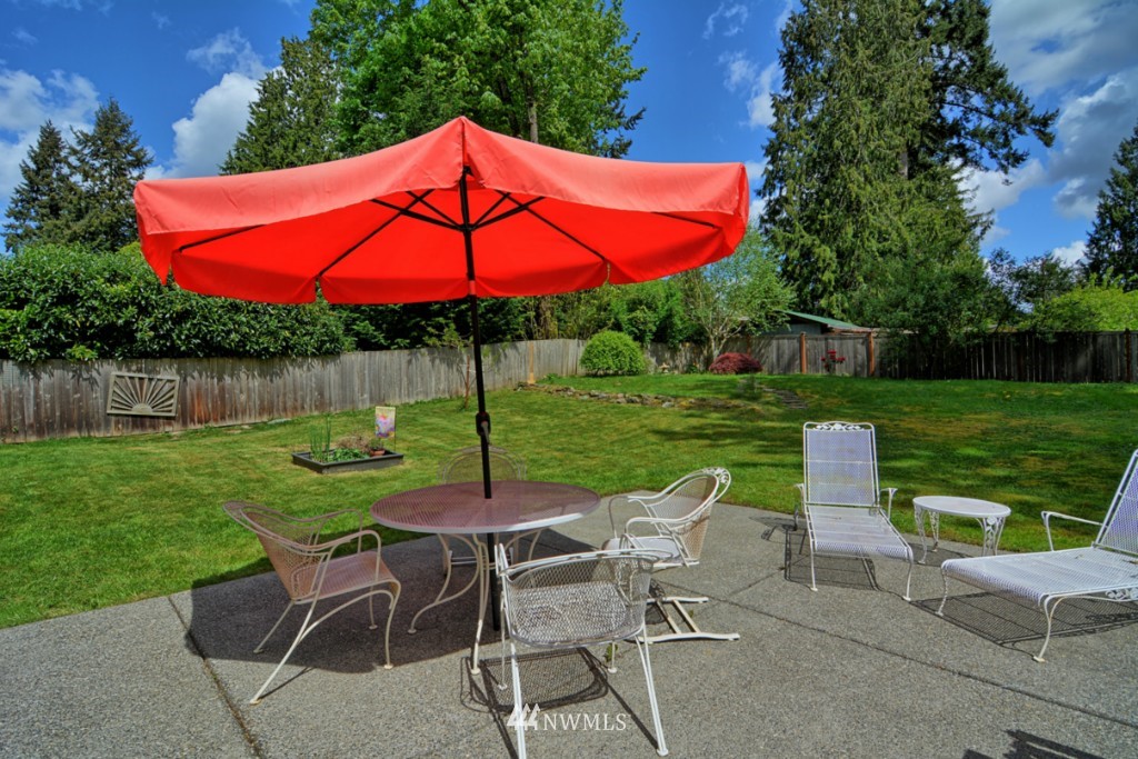 24201 3rd Place West Bothell, WA 98021 - Photo 14 of 18 a view of a table and chairs under an umbrella