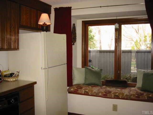 4351 Southwind Drive Raleigh, NC 27613 - Photo 6 of 12 a white refrigerator freezer sitting inside of a kitchen