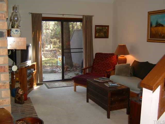 4351 Southwind Drive Raleigh, NC 27613 - Photo 7 of 12 a living room with furniture and a fireplace