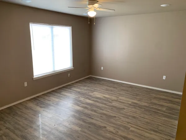 a view of walk in closet with wooden floor