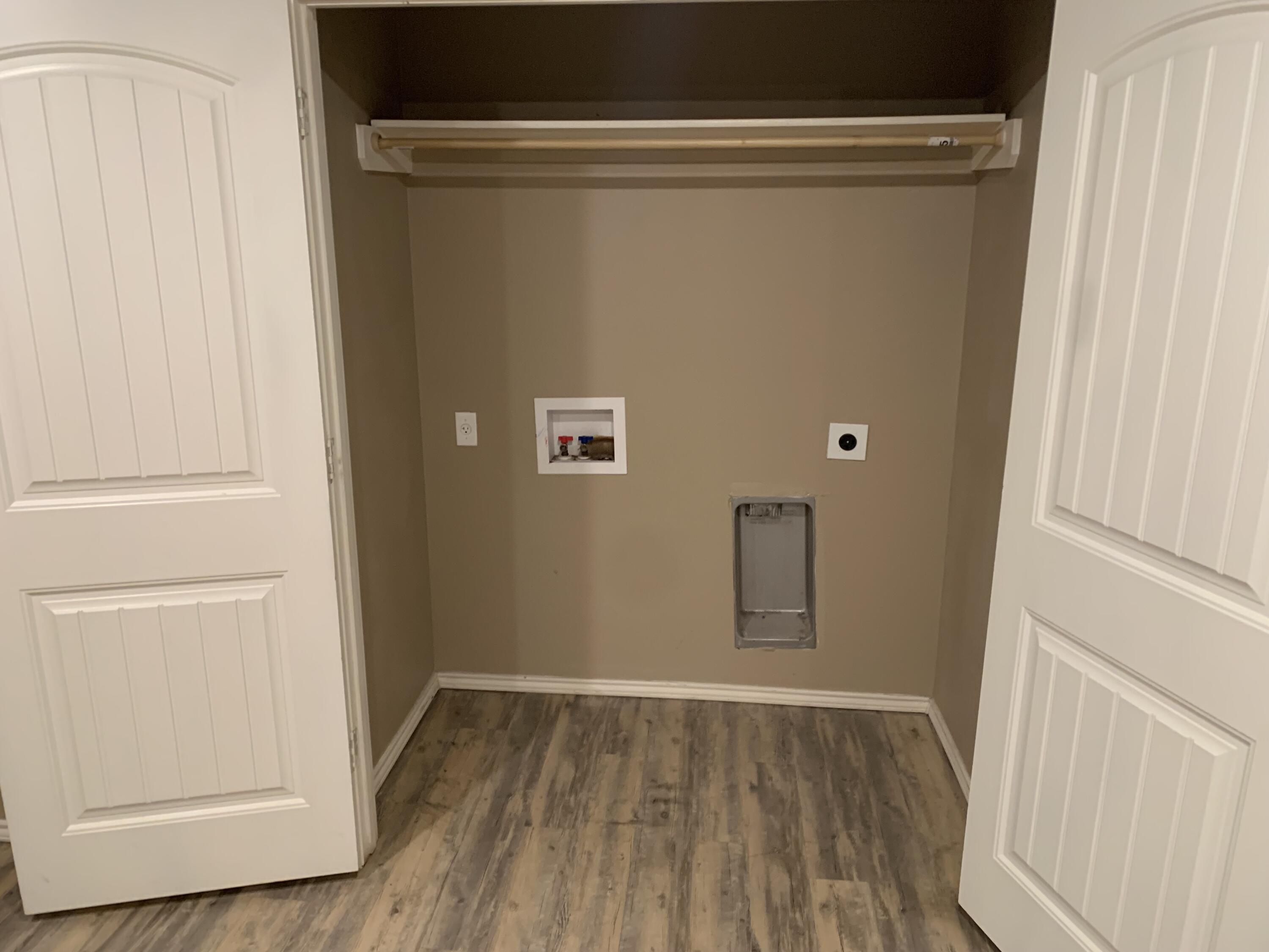 3611 East 3rd Place Lubbock, TX 79403 - Photo 4 of 8 a view of walk in closet with wooden floor