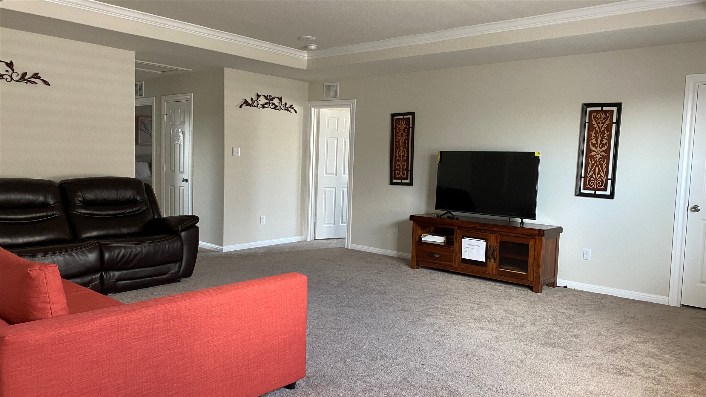 197 Prairie Falcon Way Leander, TX 78641 - Photo 15 of 29 Living room featuring carpet, ornamental molding, and a tray ceiling