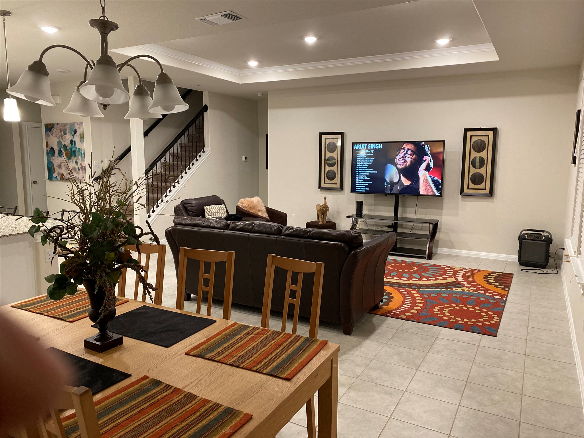 197 Prairie Falcon Way Leander, TX 78641 - Photo 6 of 29 Living area featuring light tile patterned flooring, ornamental molding, recessed lighting, and a raised ceiling