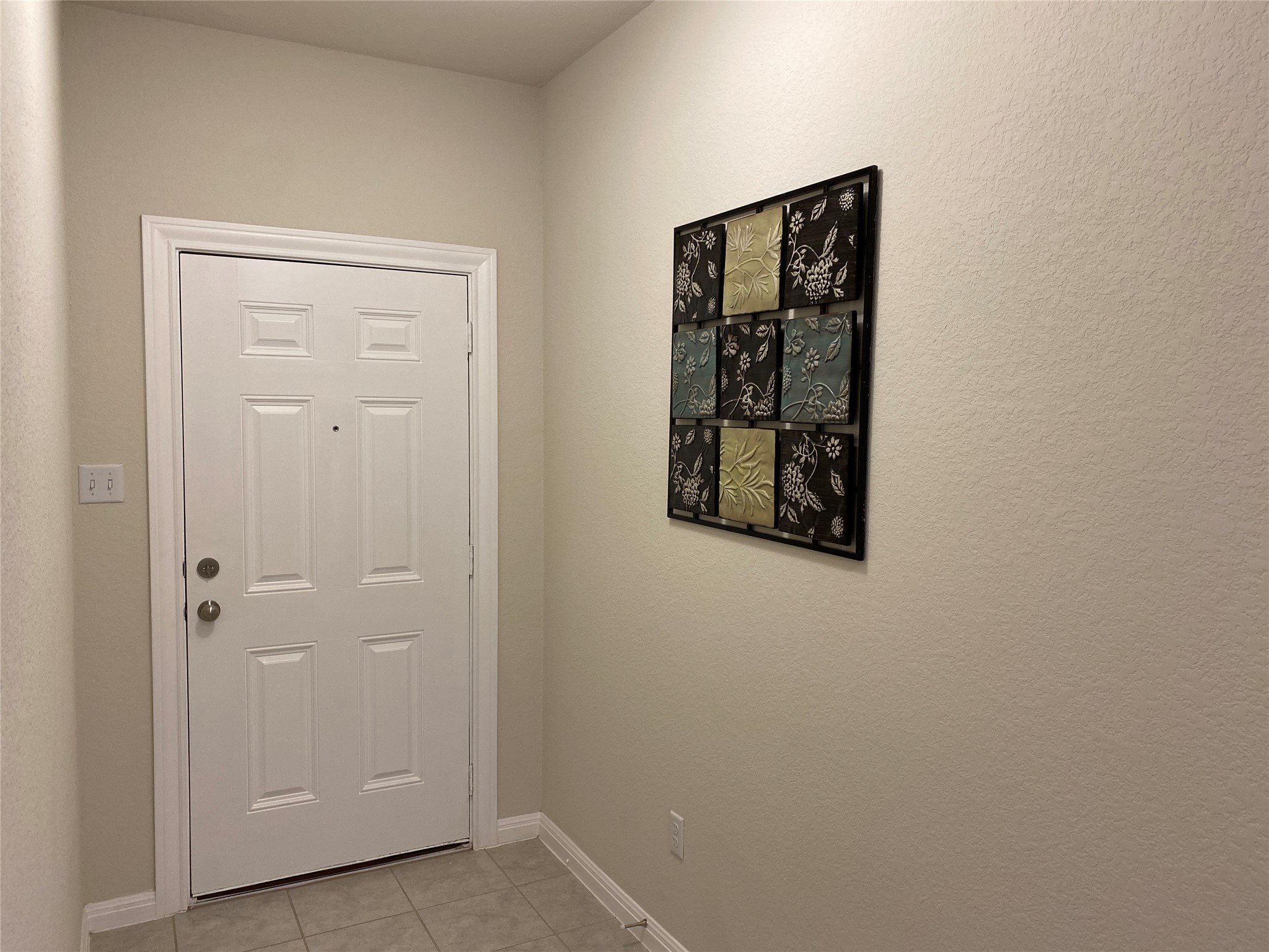 197 Prairie Falcon Way Leander, TX 78641 - Photo 10 of 29 Doorway featuring baseboards and tile patterned flooring