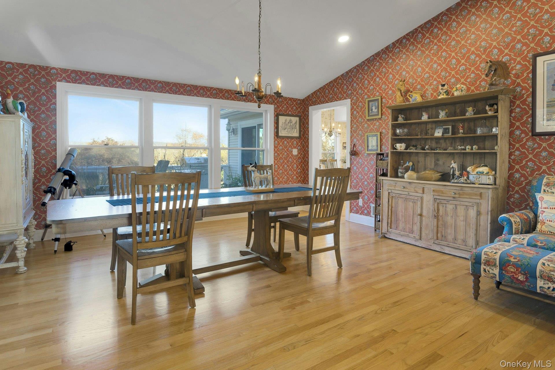 90 Cushman Road Patterson, NY 12563 - Photo 14 of 40 a dining room with wooden floor a chandelier a glass table and chairs