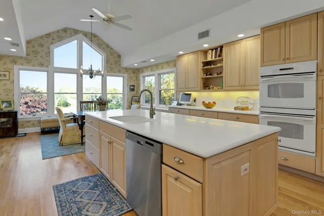 a kitchen with kitchen island a sink stove and cabinets