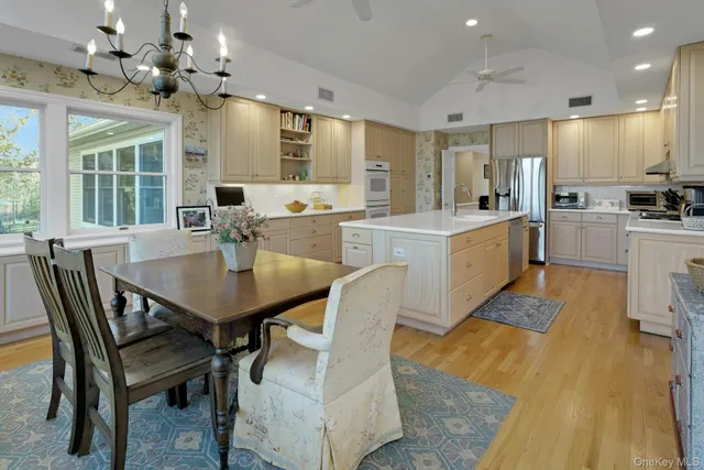 a large kitchen with a table and chairs